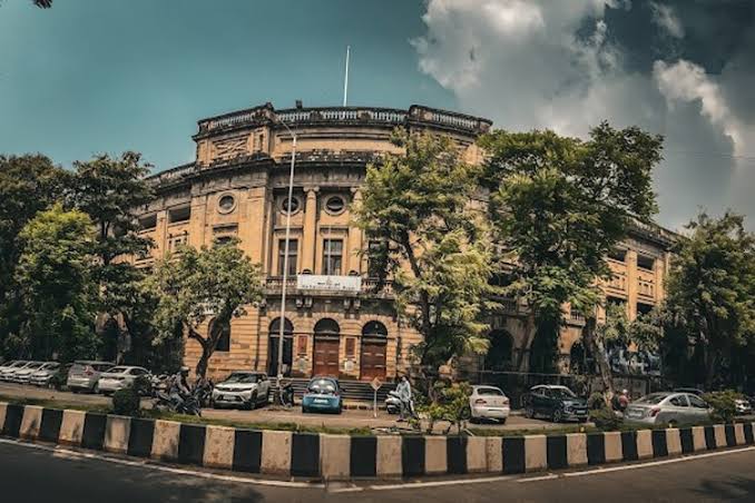 Wide street view of the curved Institute of Science heritage building